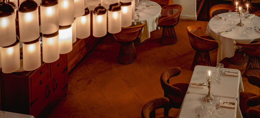 Elegant restaurant interior with unique tubular lighting and warm tones at Montesol Experimental.