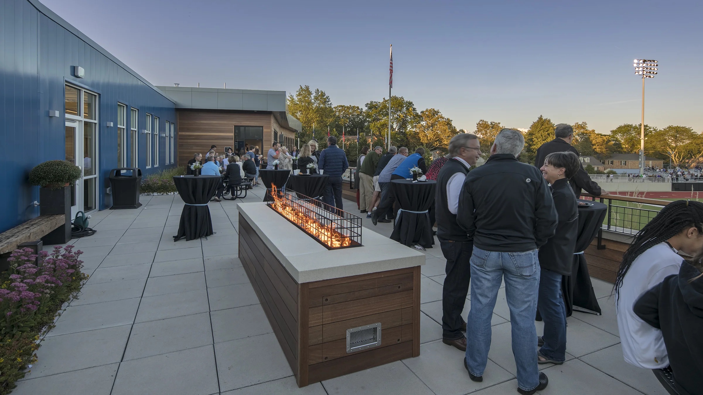 Fire table with people around it on the Grand Rapid Christian School's observation deck.