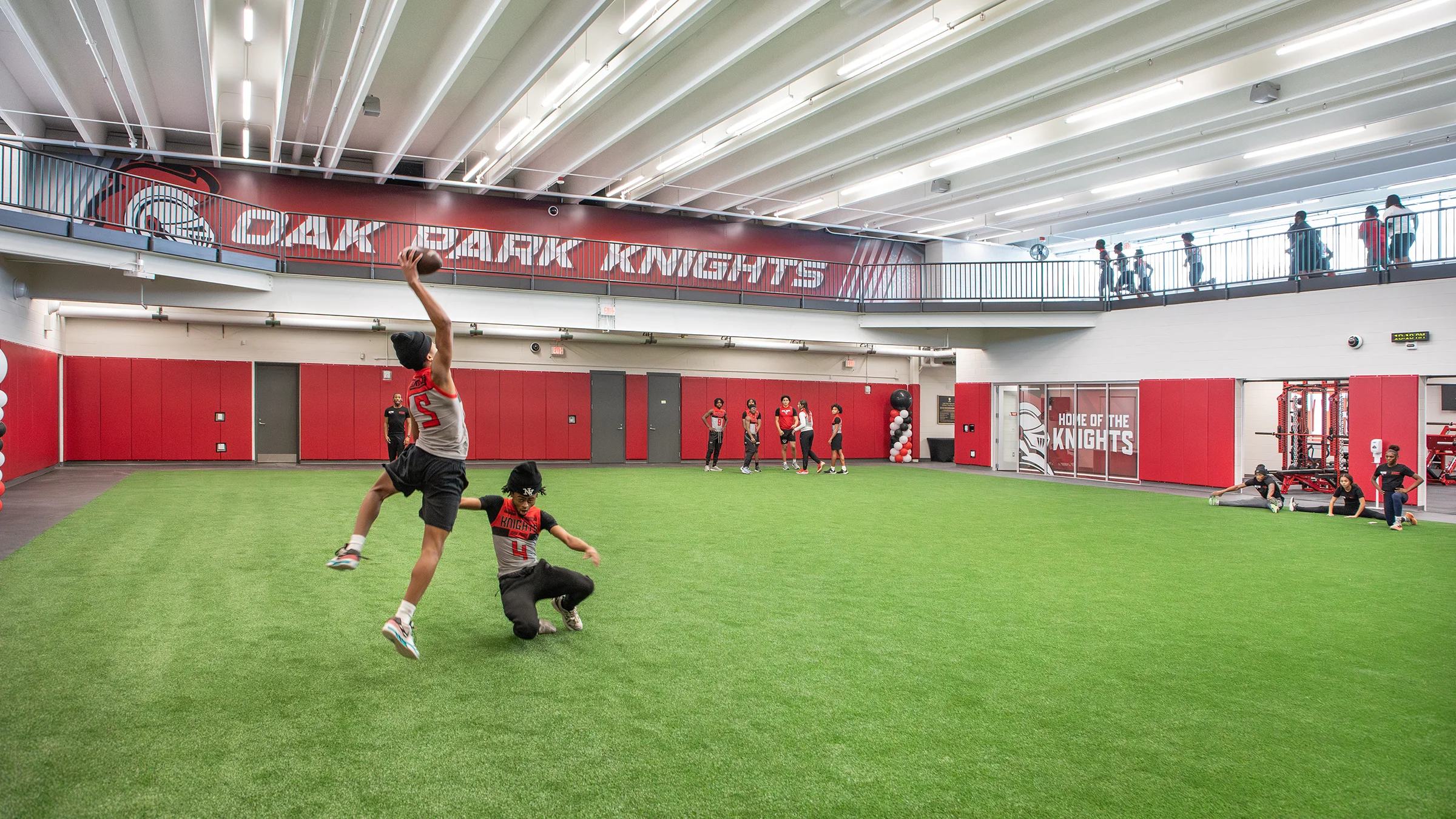 Oak Park High School athletes practicing football on the indoor turf,