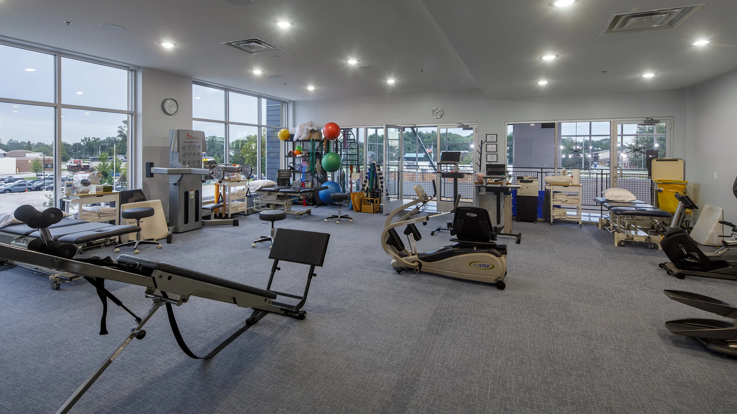 Exercise equipment and massage tables in a physical therapist's office.
