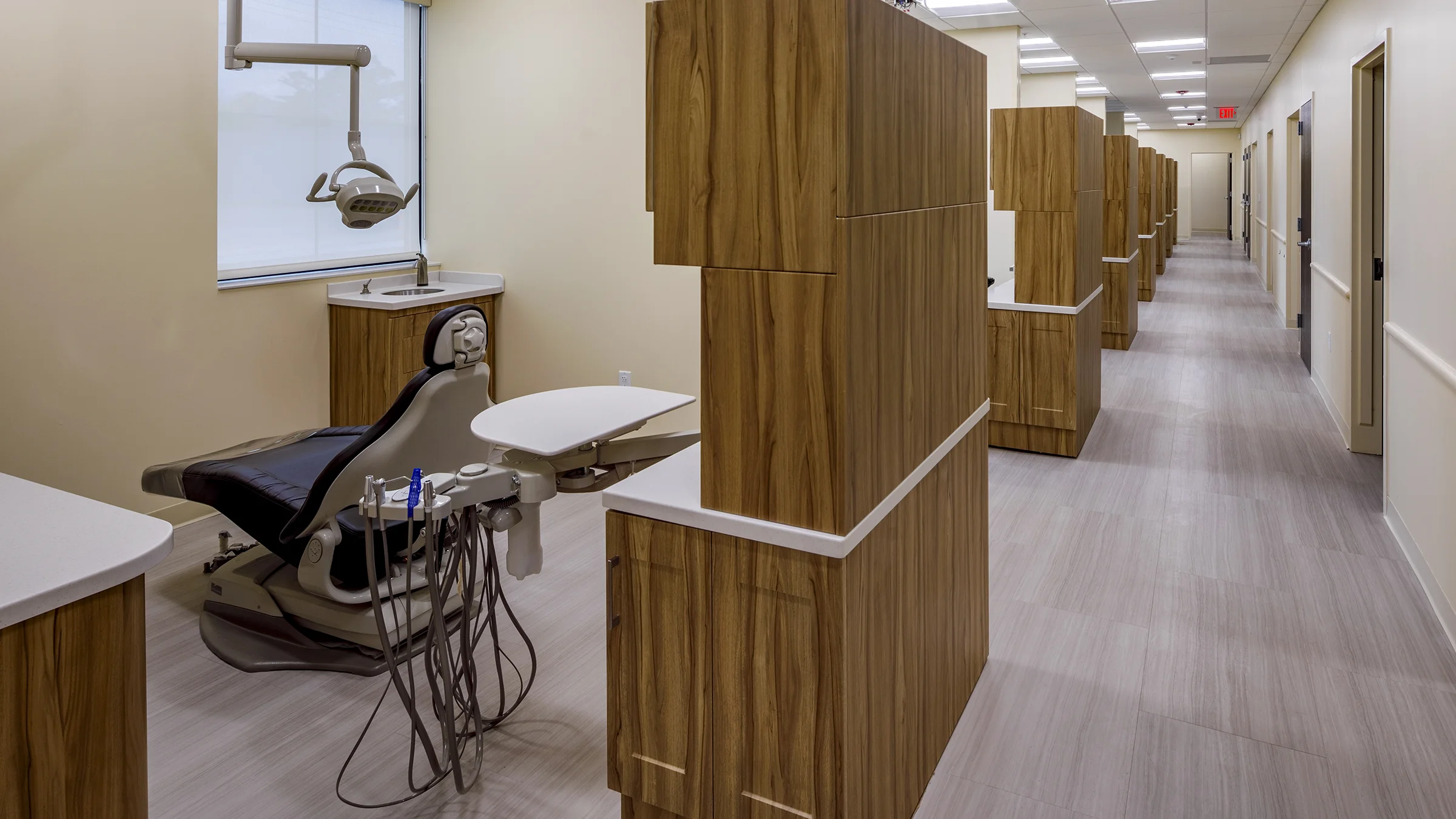 Dental office in Covenant Community Care's Joy Road Clinic. The office features yellow walls and warm wood cabinetry.