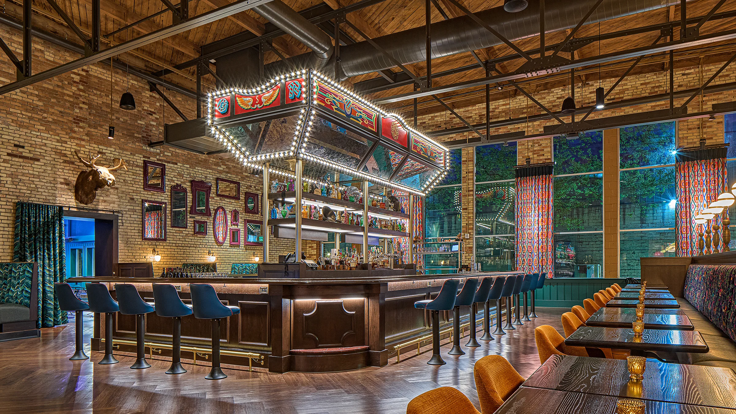 Interior of Silva restaurant. Lit up bar casino like motifs and dark wood accents.