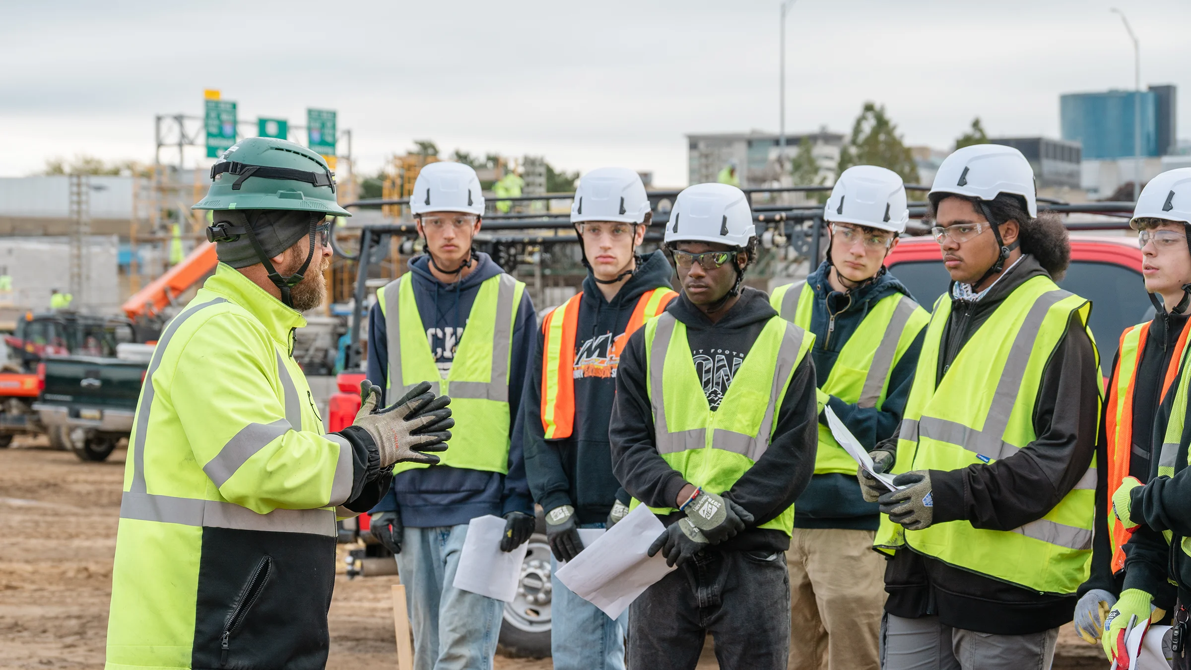 WCMI construction students wearing PPE meeting with Rockford safety team at the Amway Stadium.