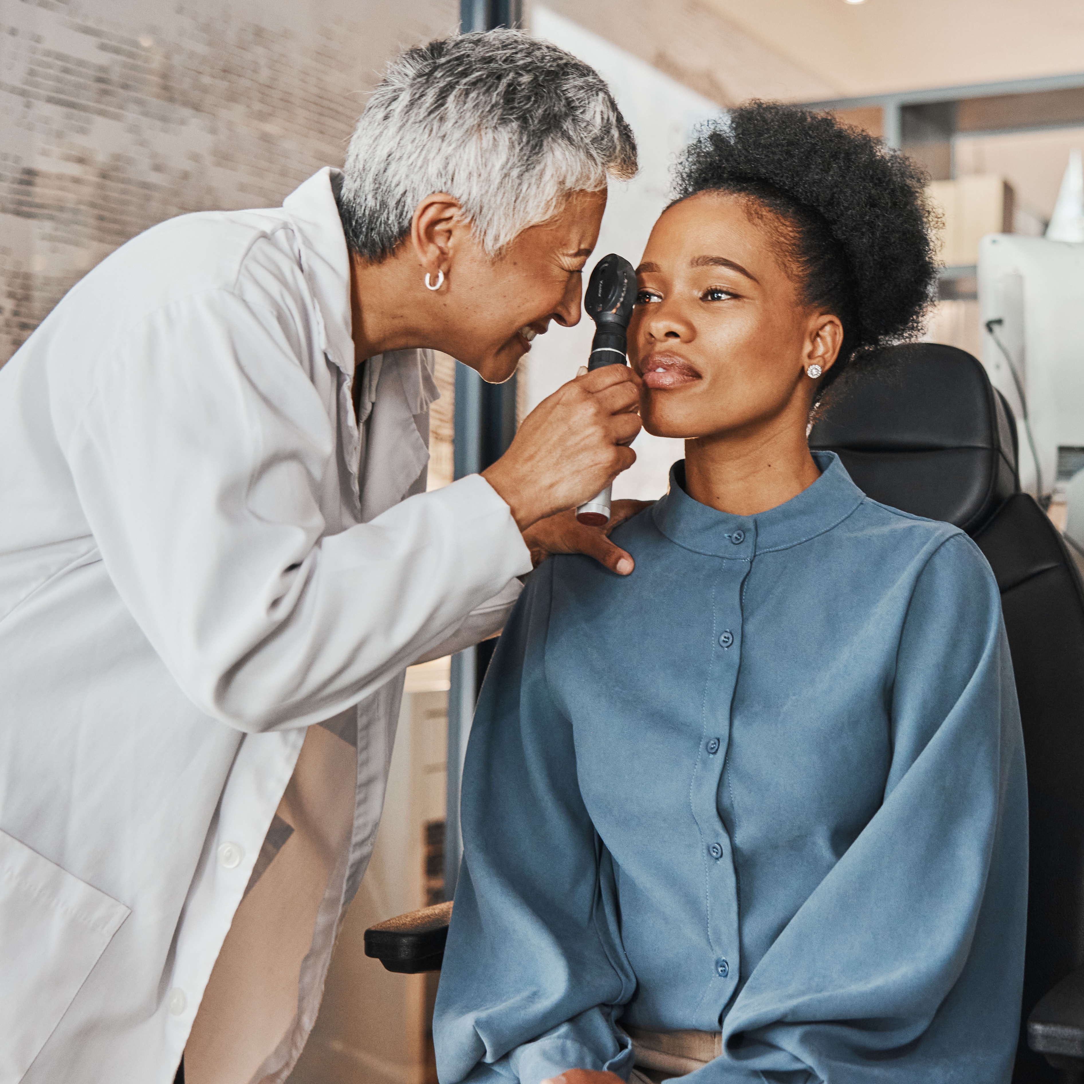 Optician testing eyes