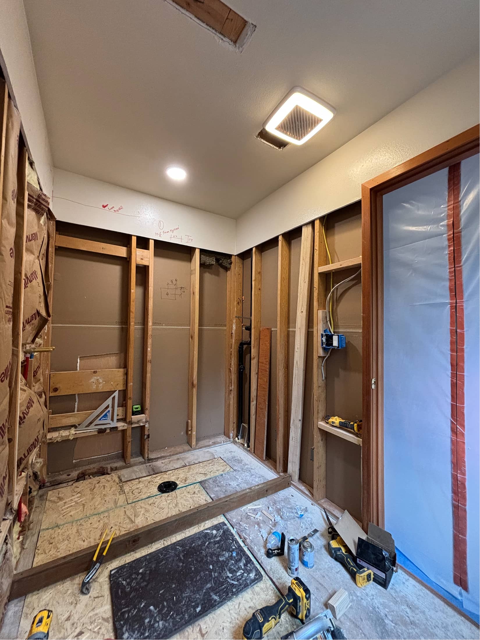 Bathroom remodel framing with new ventilation fan and electrical rough-in by NBE LLC