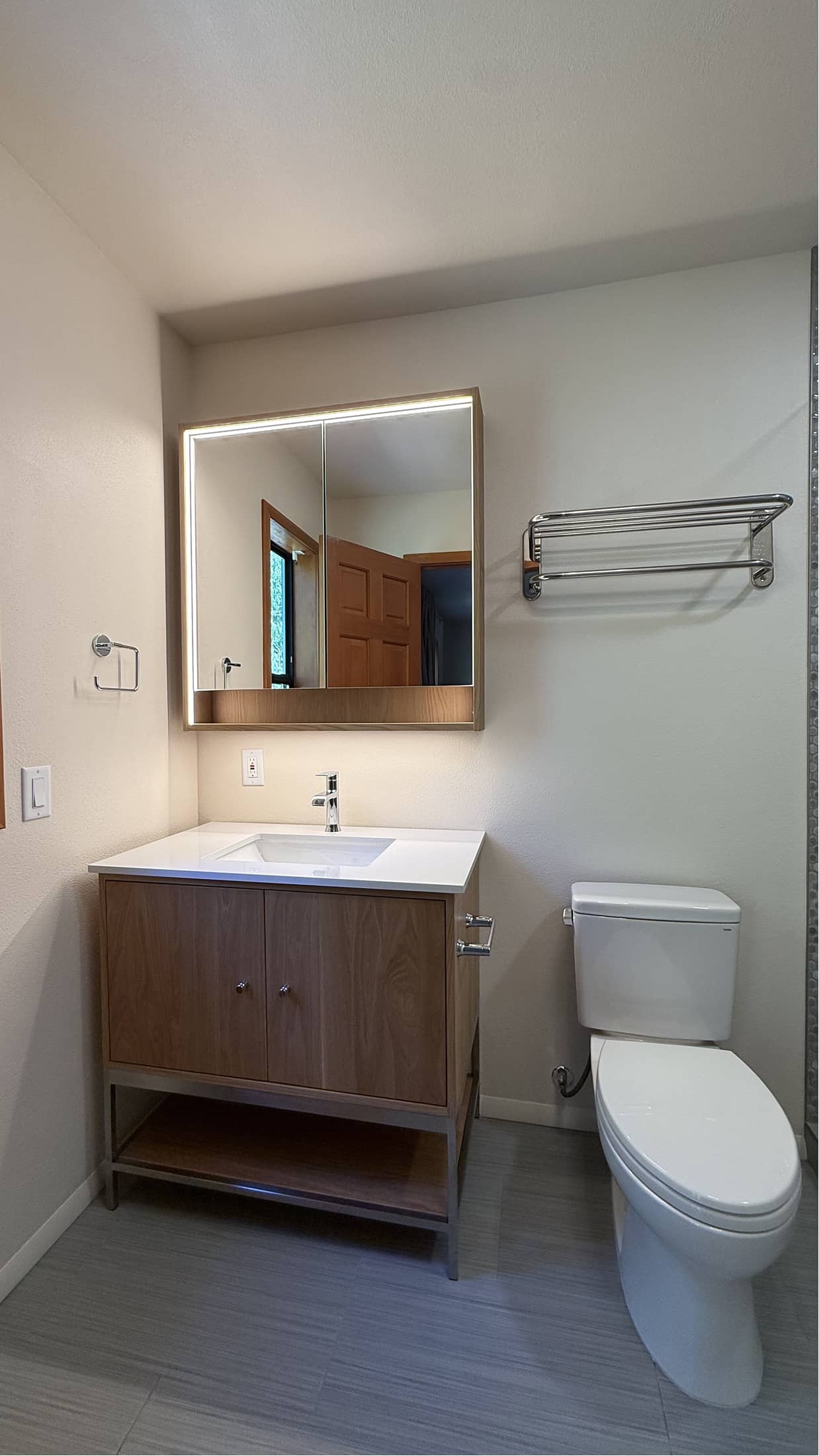 Updated half bath with walnut vanity and LED medicine cabinet in Renton by NBE LLC