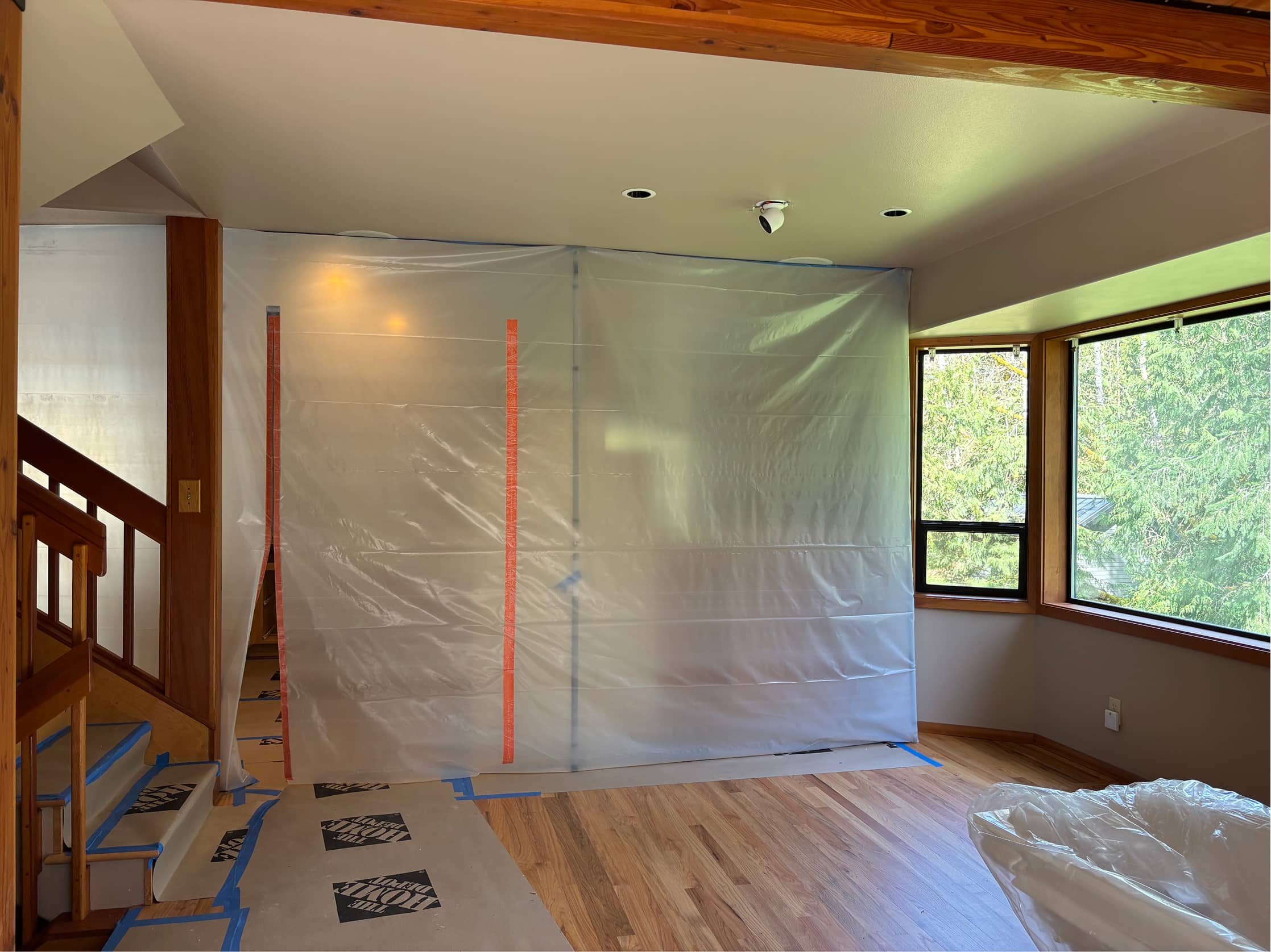 Active home remodel with plastic dust barriers and floor protection by NBE LLC