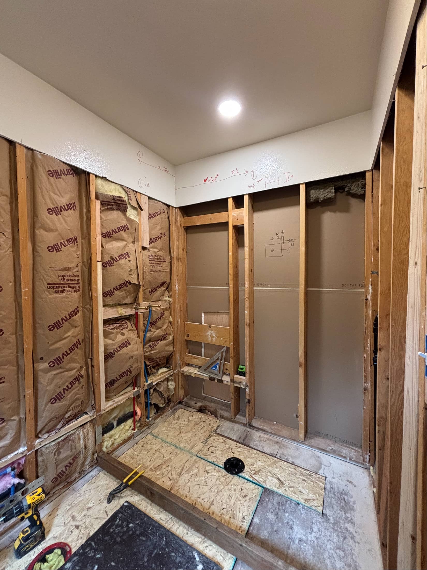 Bathroom renovation with insulation and framing during tub-to-shower conversion by NBE LLC