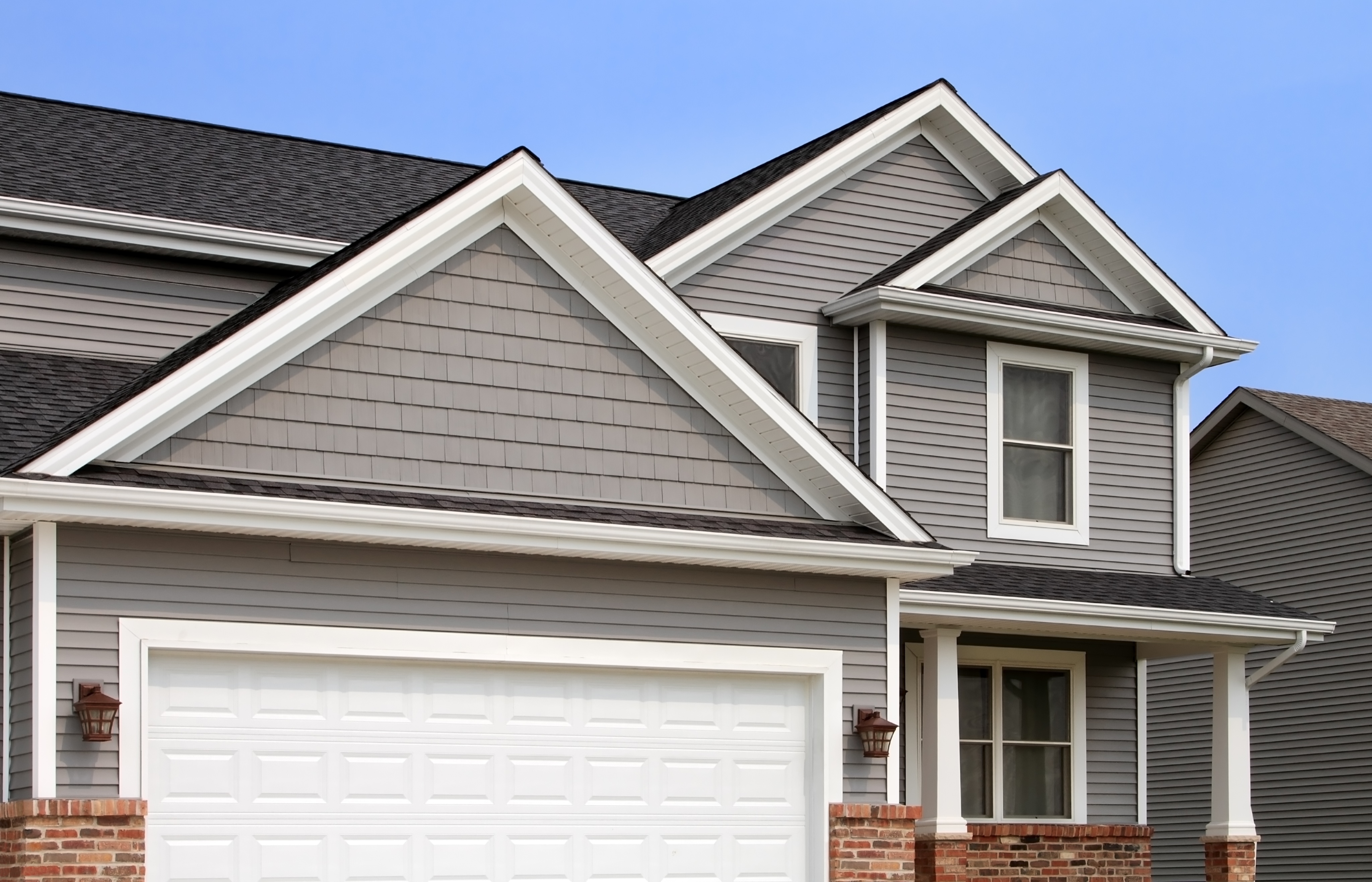 A house with gray vinyl siding and white trim