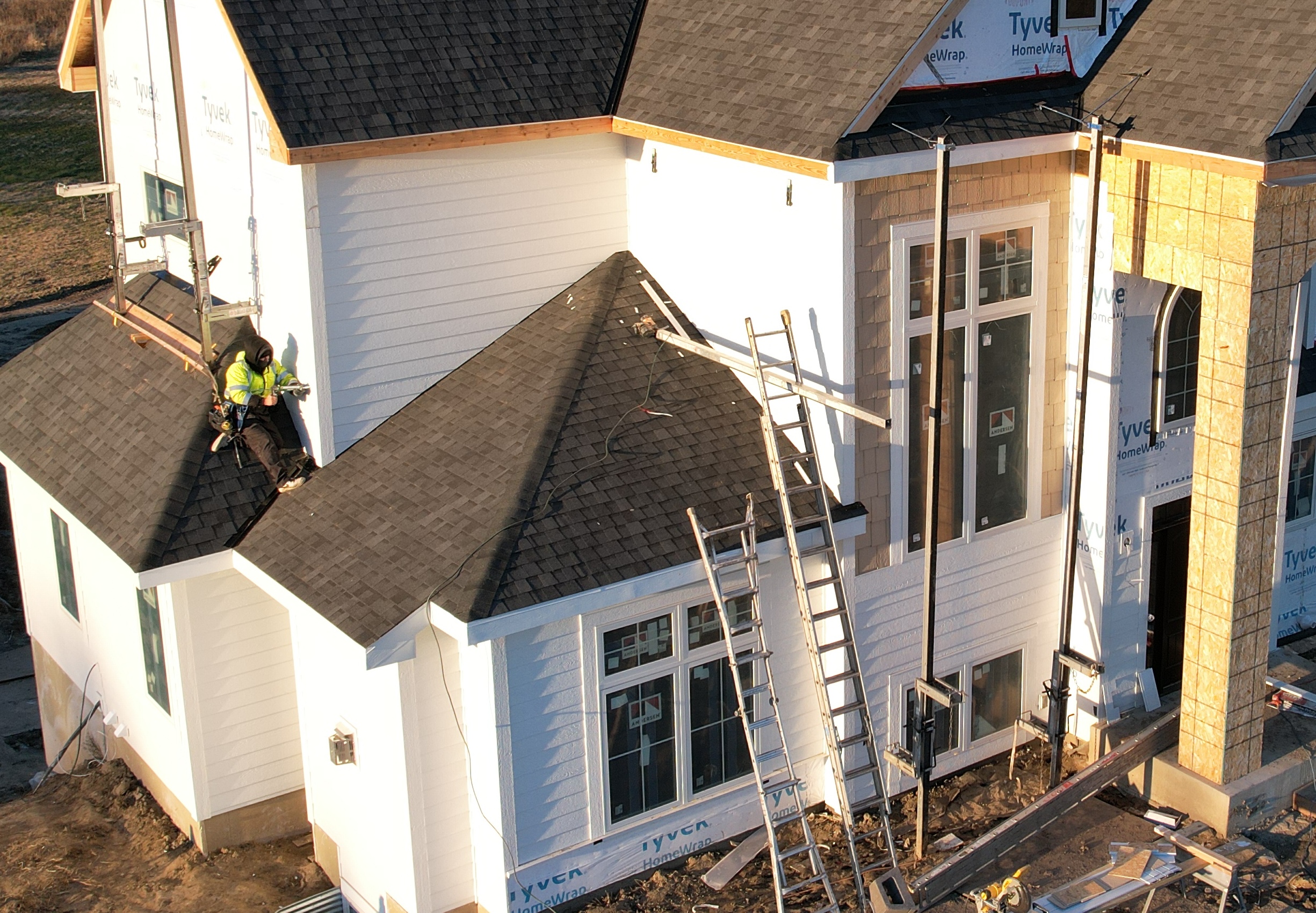 A house with white and tan LP SmartSide siding being installed