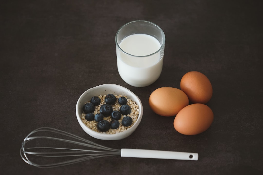 Healthy student breakfast with oatmeal, berries, eggs, and whole grain toast arranged on a table