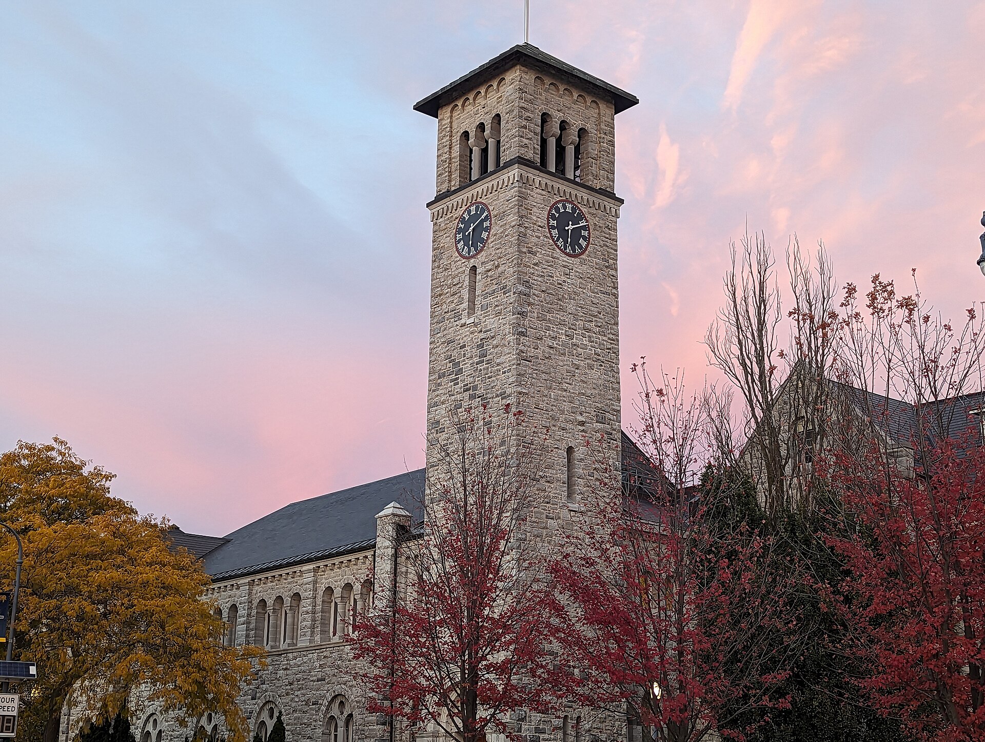 Grant Hall clock tower at sunset in autumn, Queen's University