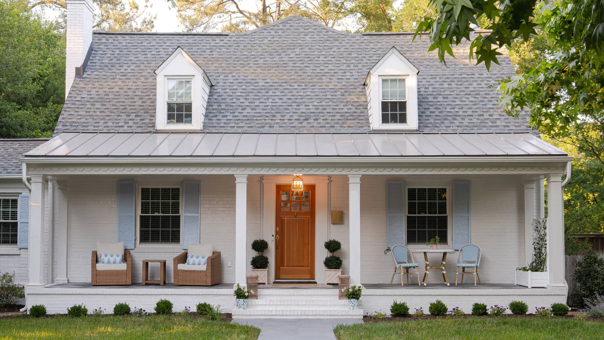 Front exterior of a Willow Lawn home in Richmond, VA, featuring a new full-width covered porch and walkway leading to the front entrance.