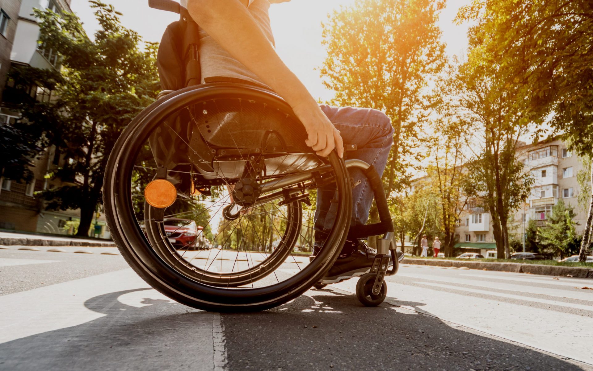Handicapped man in wheelchair crossing street road