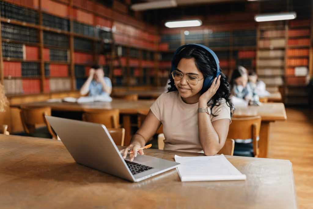 Female Indian student working on the laptop in the university library