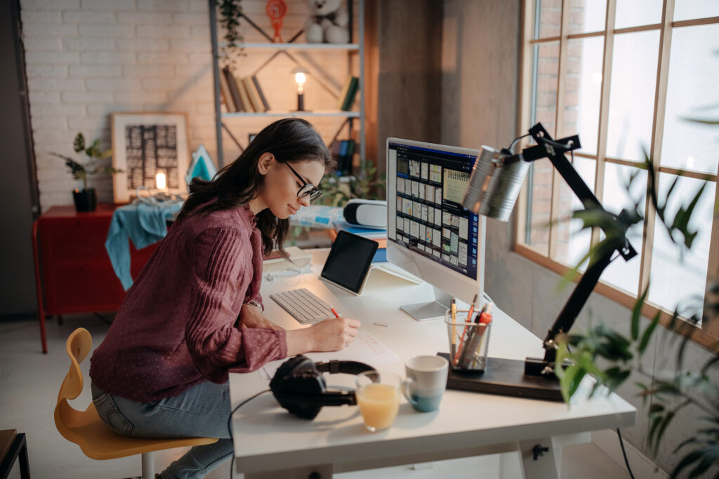 Young beautiful photographer working from home office
