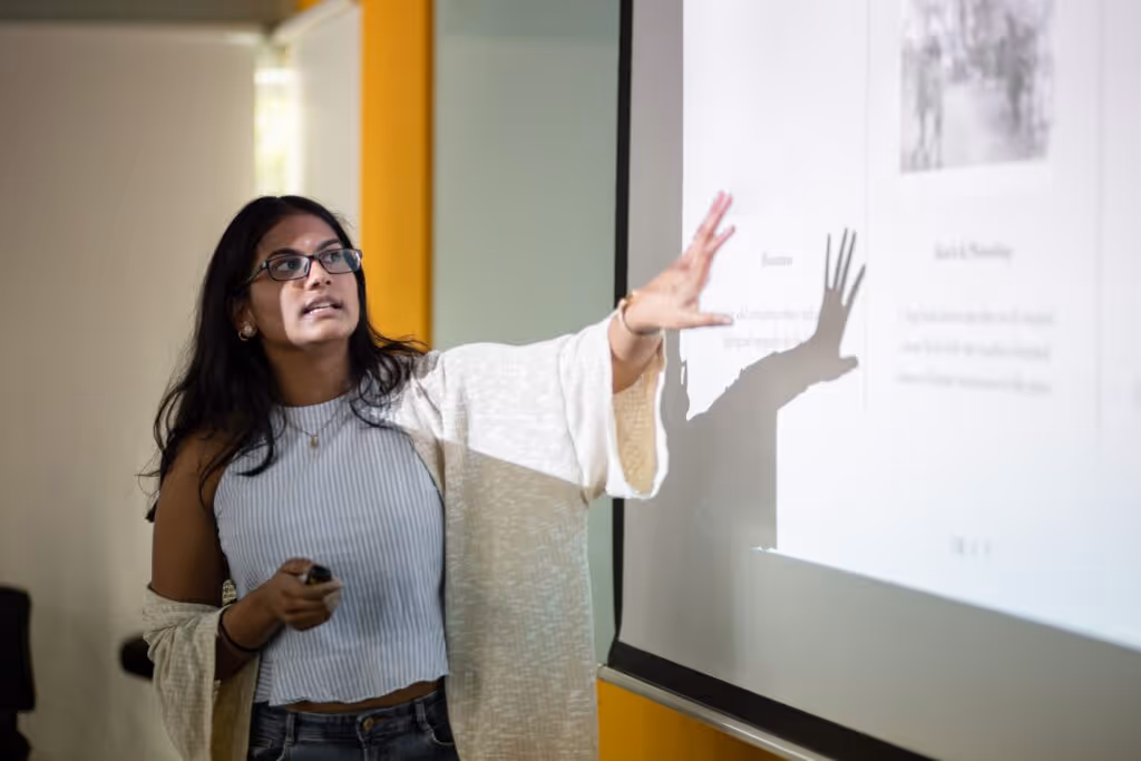 A women presenting a presentation with a school presentation theme