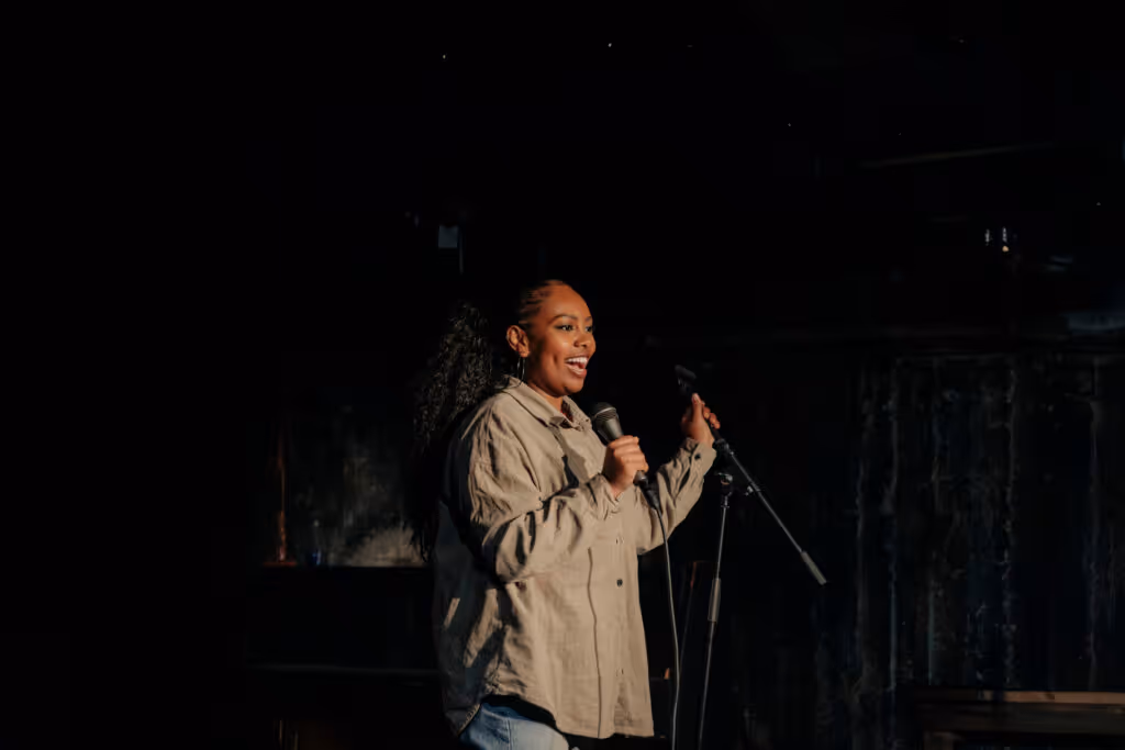 A woman performing on stage, telling a story.