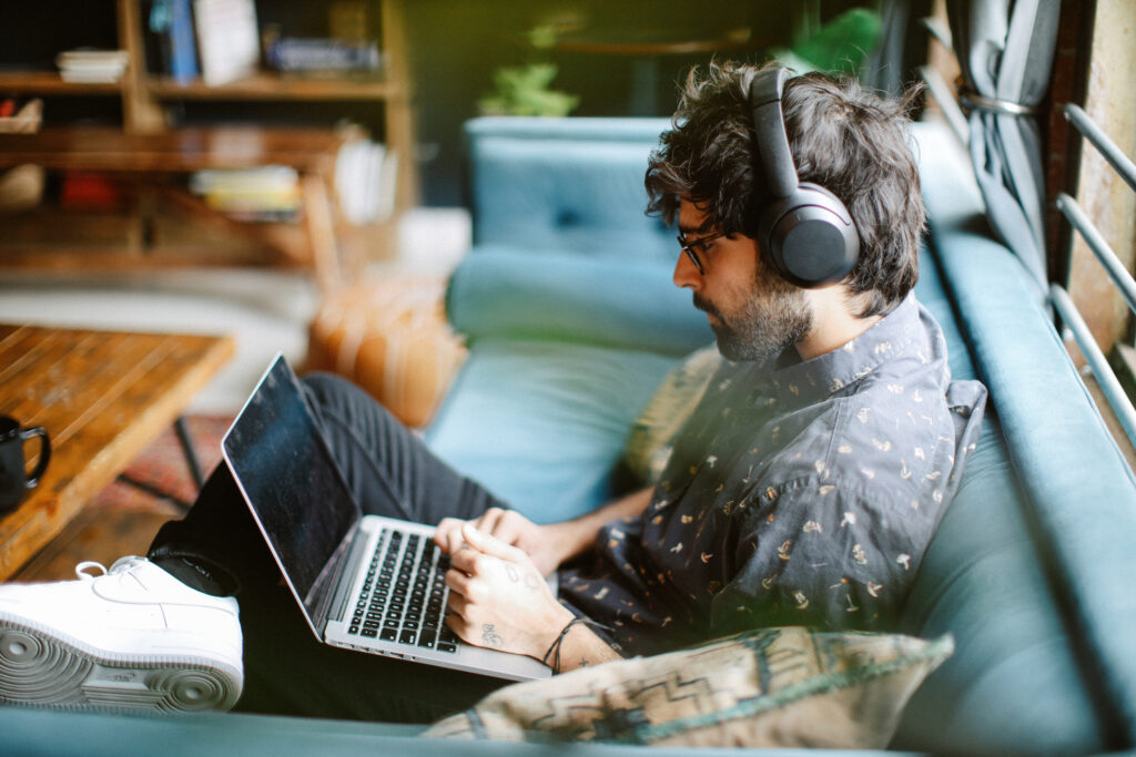 Young man adding music to slideshow presentation.