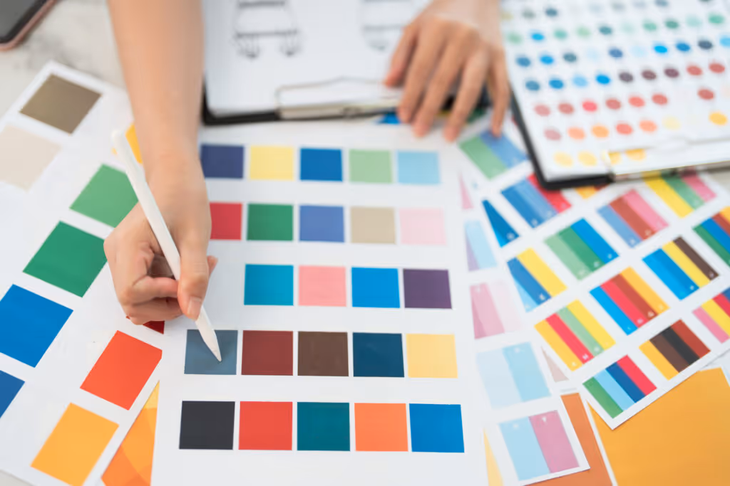 Graphic designer at work. Color swatch samples. Artist drawing something on graphic tablet at the office. Graphic designer creativity editor ideas designer concept.