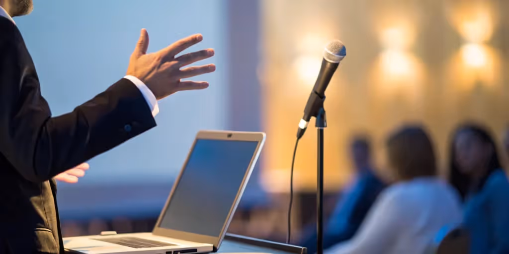 A person on stage giving a presentation and avoiding common mistakes.