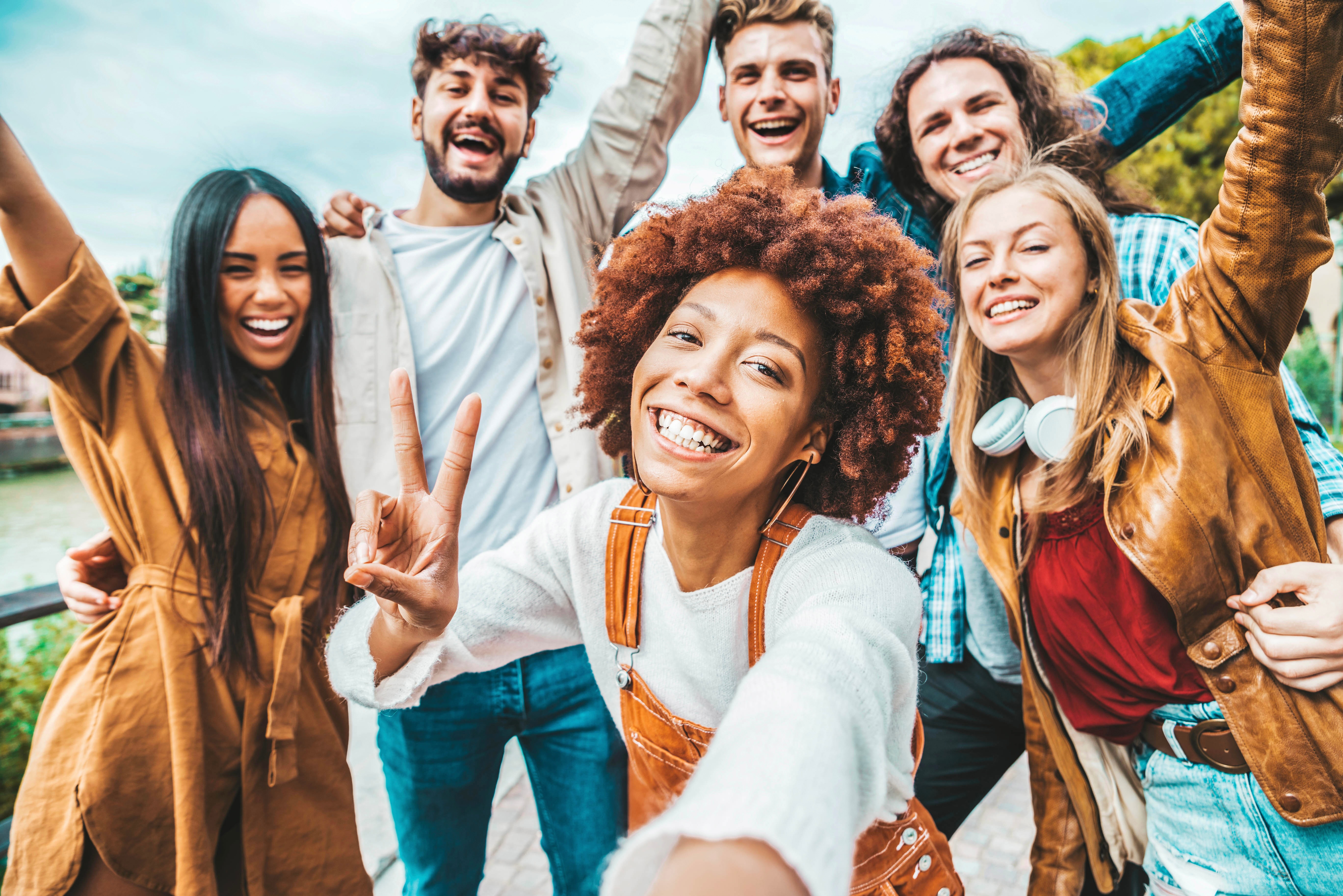 Large group picture of friends is colorful clothing smiling stock image