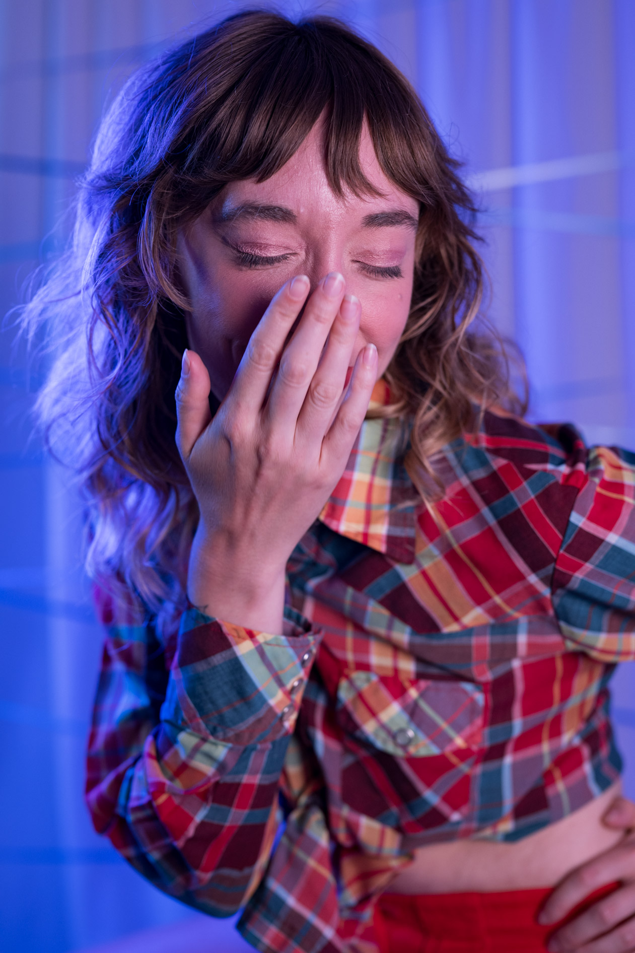 kayla laughs, wearing plaid