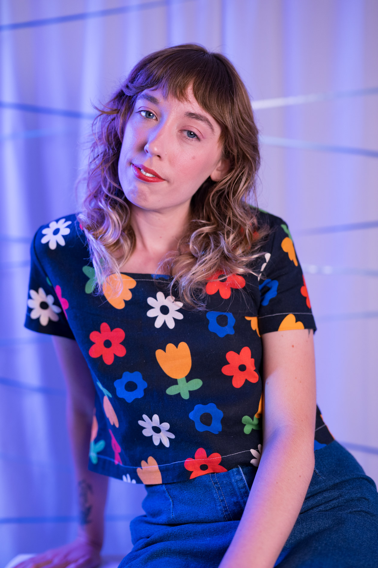 kayla with a sweet smile and a floral top