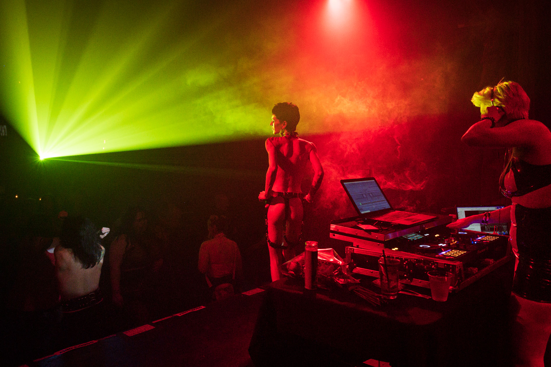 a go go dancer moves under the lights on stage at an event in downtown Portland