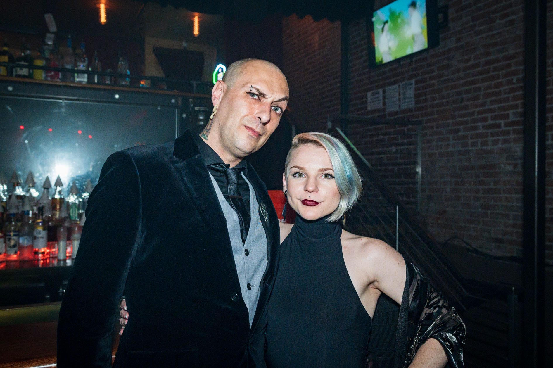 a handsome couple poses for the camera at a dance event in downtown Portland