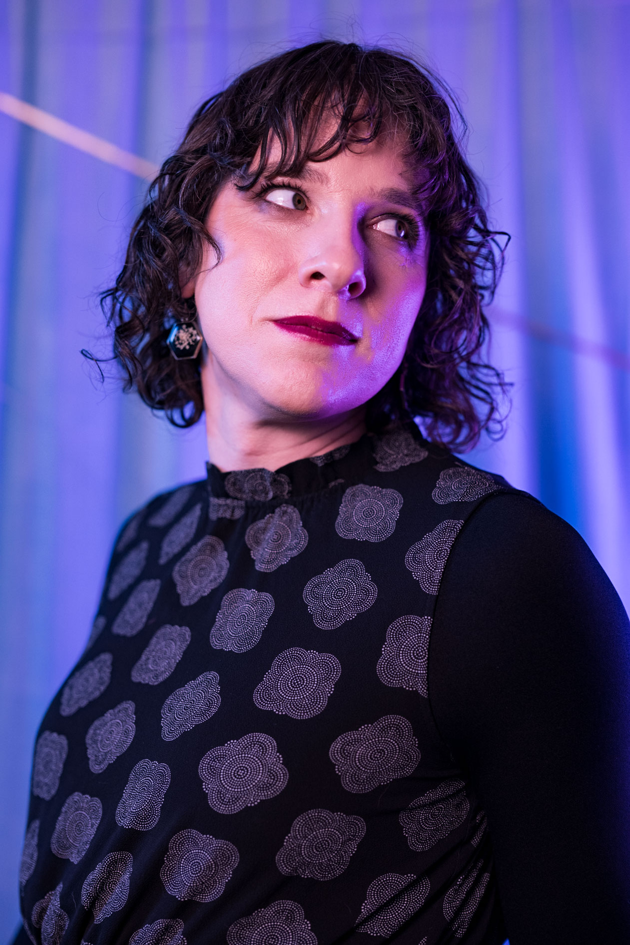 a beautiful trans woman looks over her shoulder in the SE Portland studio