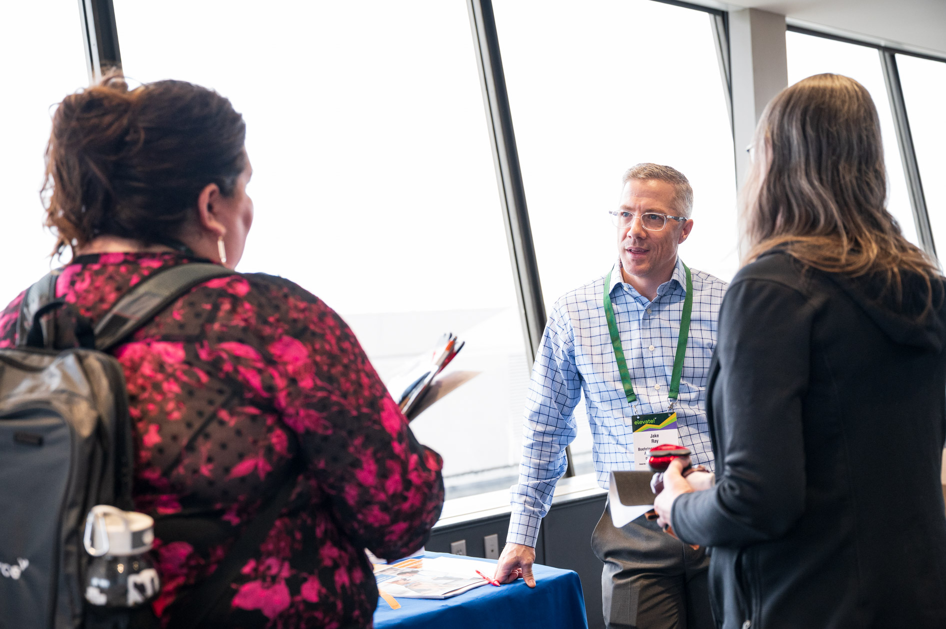colleagues in pet healthcare discuss products at an event in downtown Portland