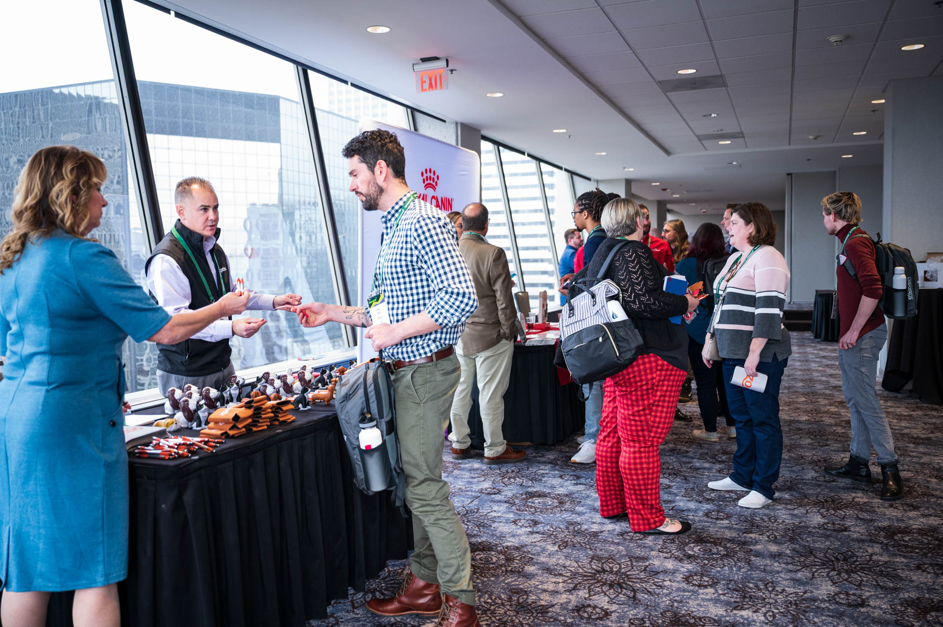booths and attendees wander at an event in downtown Portland
