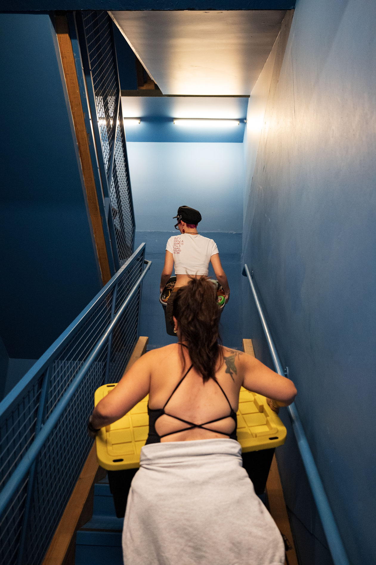 family members carry a student's belongings up the stairs at PNCA in downtown Portland
