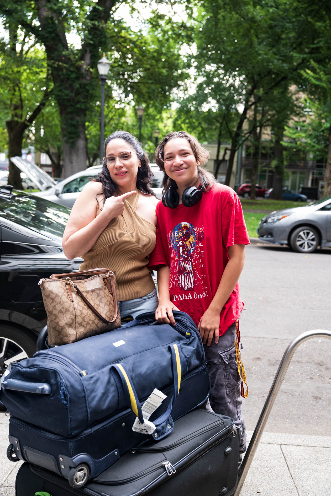 a family member poses with a PNCA student outside a dorm in downtown Portland