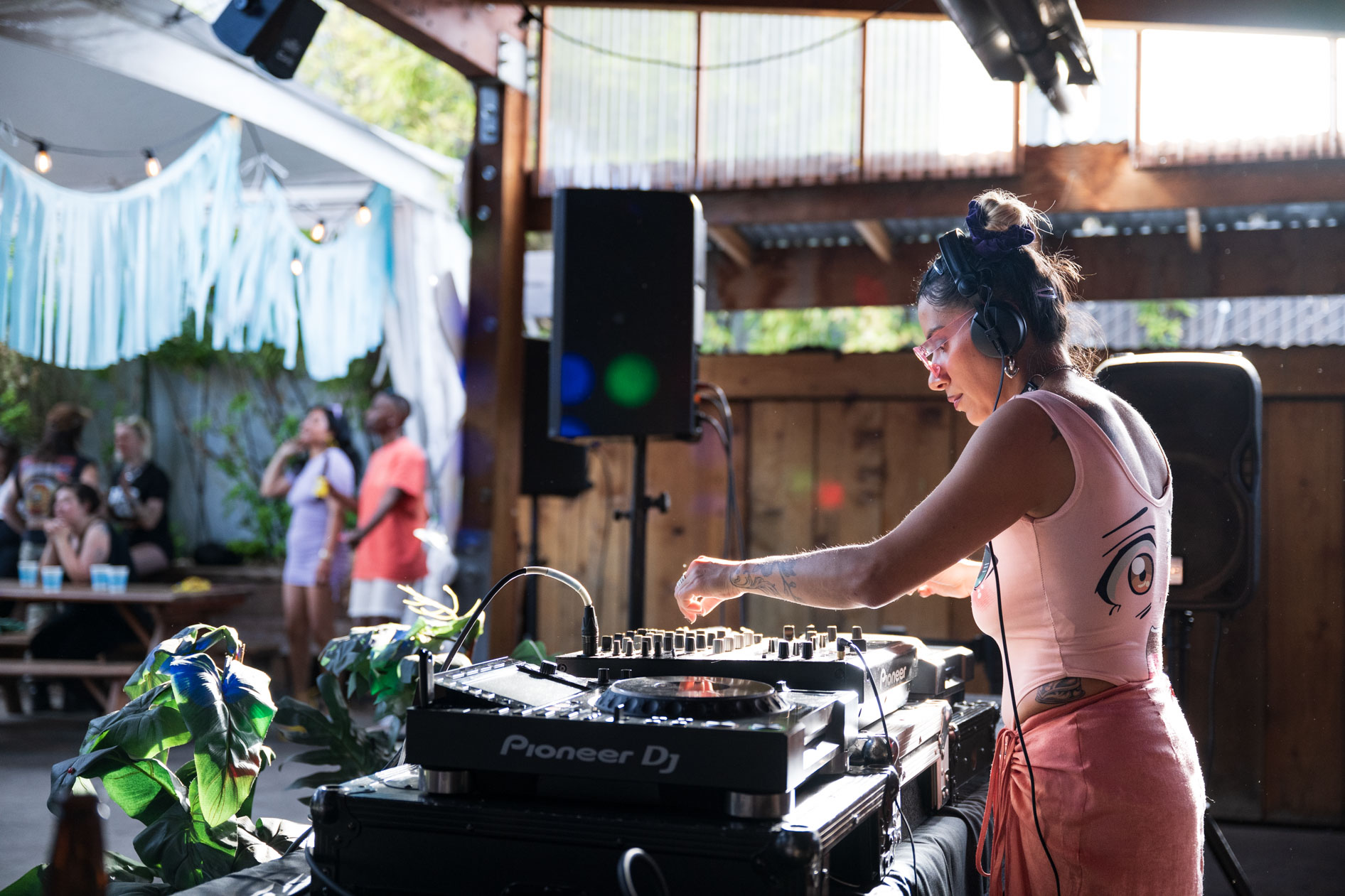 A candid photo of DJ Lapaushi performing a set at an outdoor event. This is an example of commercial photography for an artist's portfolio.