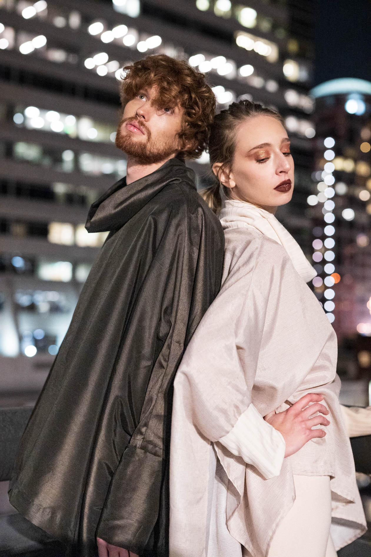 A commercial portrait of two models wearing clothing from the boutique brand Ale O, posing at night with the city lights in the background. This image showcases lifestyle brand photography in Portland, Oregon.