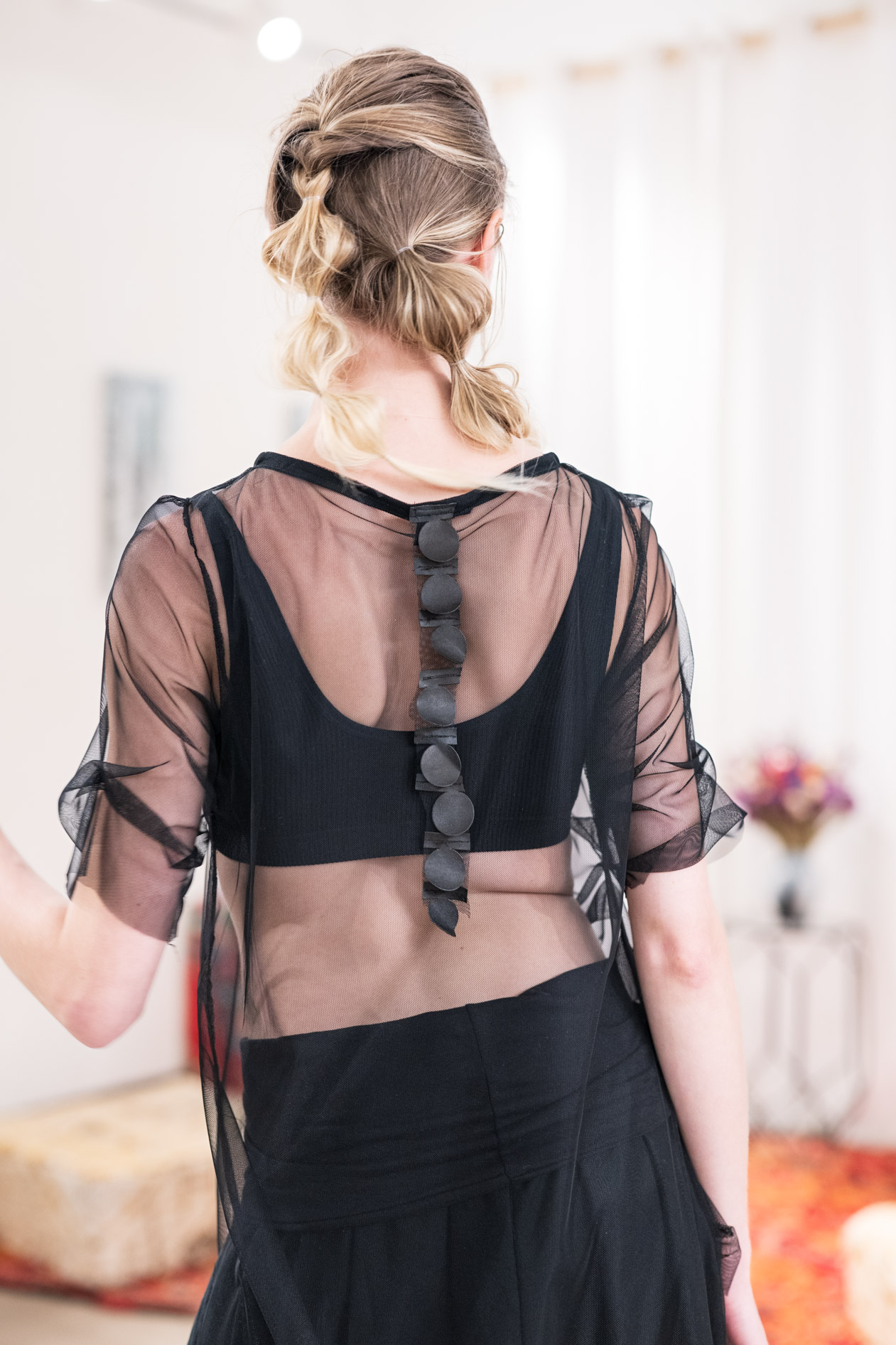 A commercial photograph of the back of a model in a black sheer top from the boutique brand Ale O. This showcases lifestyle brand photography in Portland, Oregon.