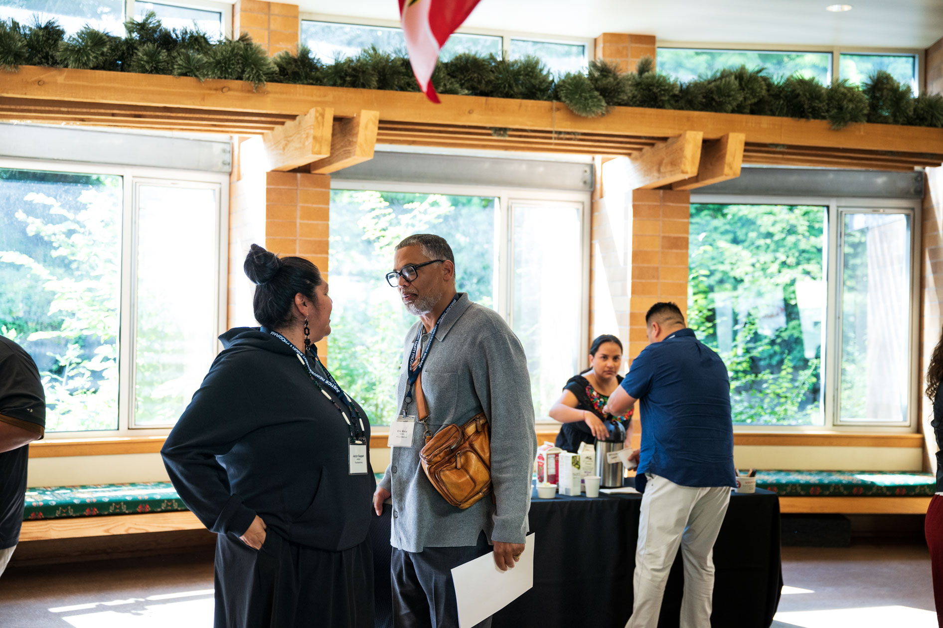 A candid photograph of two JREP grantees networking during a break at the Northwest Health Foundation convening event. This showcases nonprofit event photography.