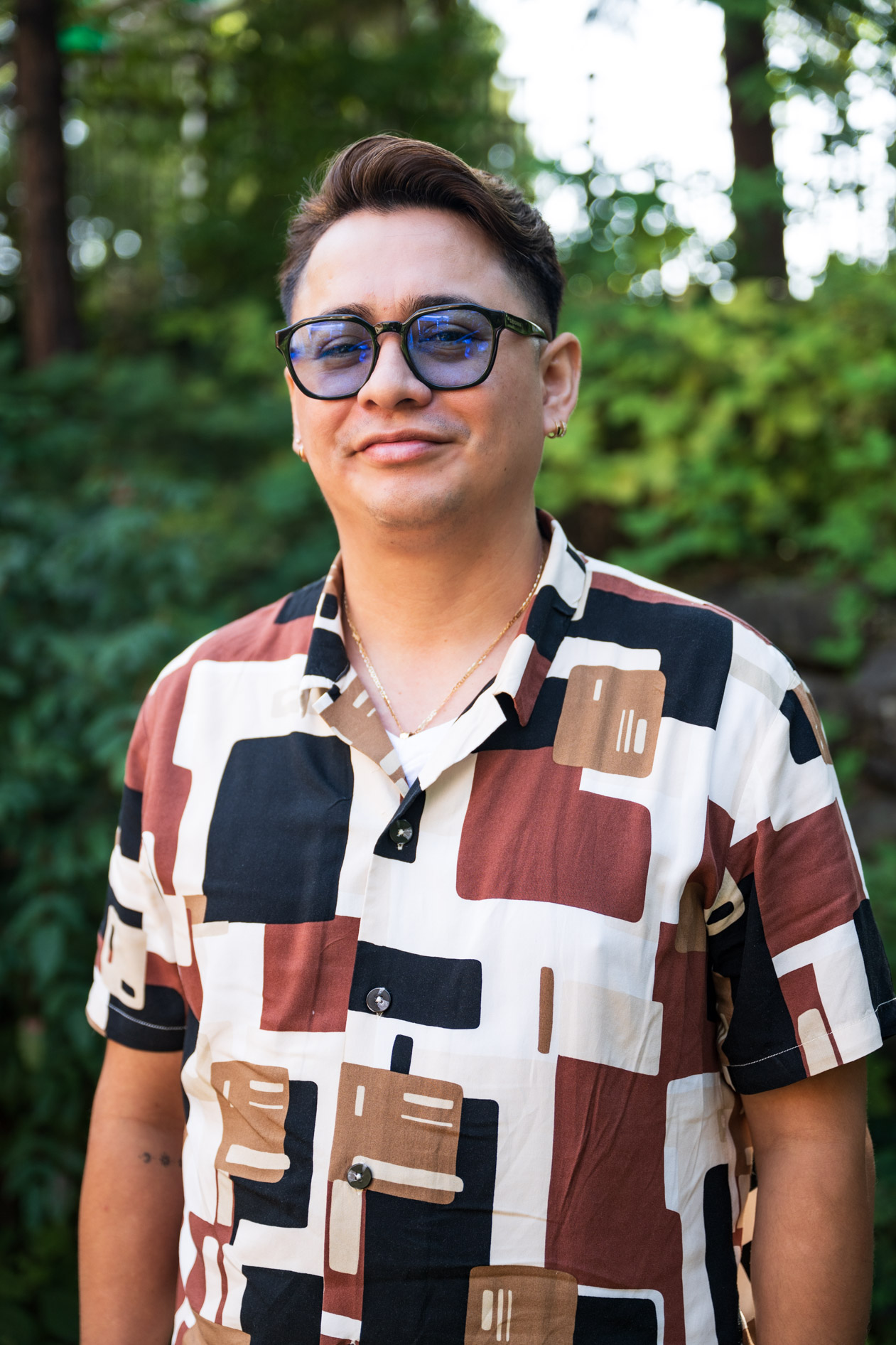 A smiling inclusive headshot of a JREP grantee wearing a patterned shirt, captured at the Northwest Health Foundation event.