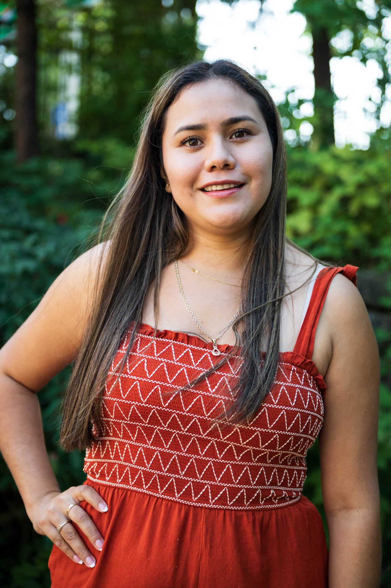 A smiling inclusive headshot of a JREP grantee in a red top, captured outdoors at the Northwest Health Foundation event.