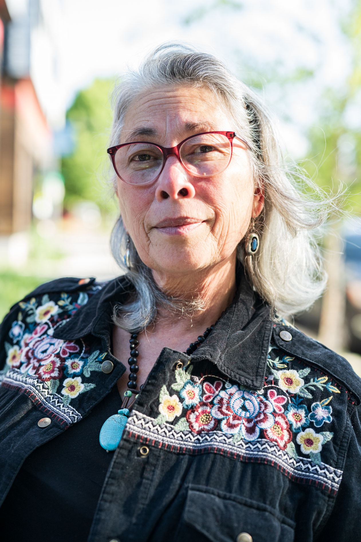 Portland entrepreneur poses in a black flowered shirt
