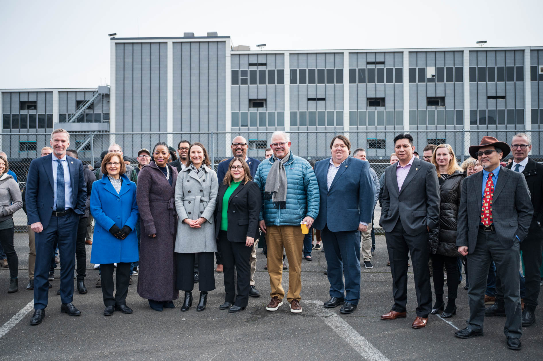 A group portrait of Portland elected officials and leaders gathered by Prosper Portland for the downtown post office demolition event.