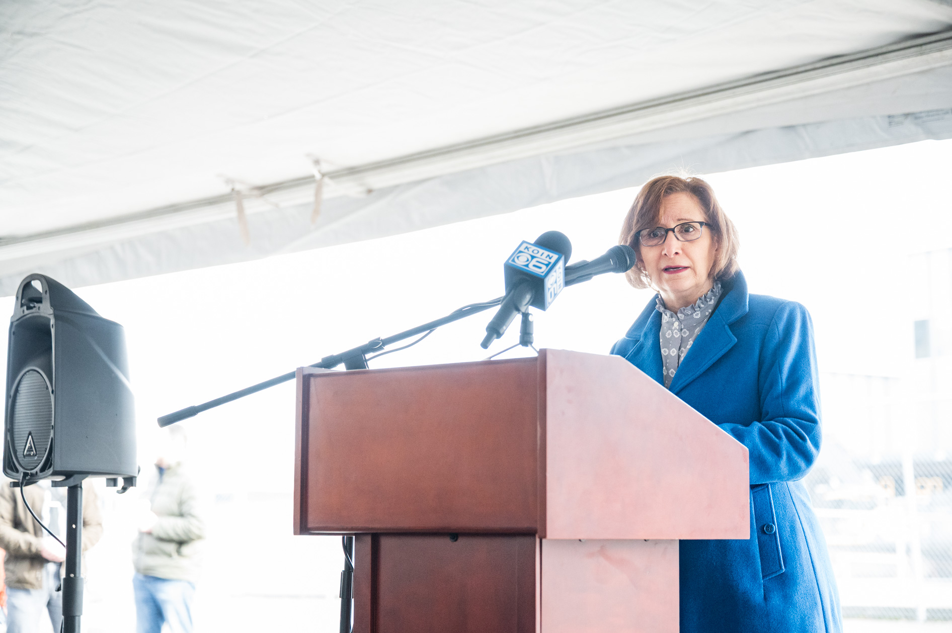 Representative Suzanne Bonamici speaking at a podium during the downtown post office demolition event for Prosper Portland.