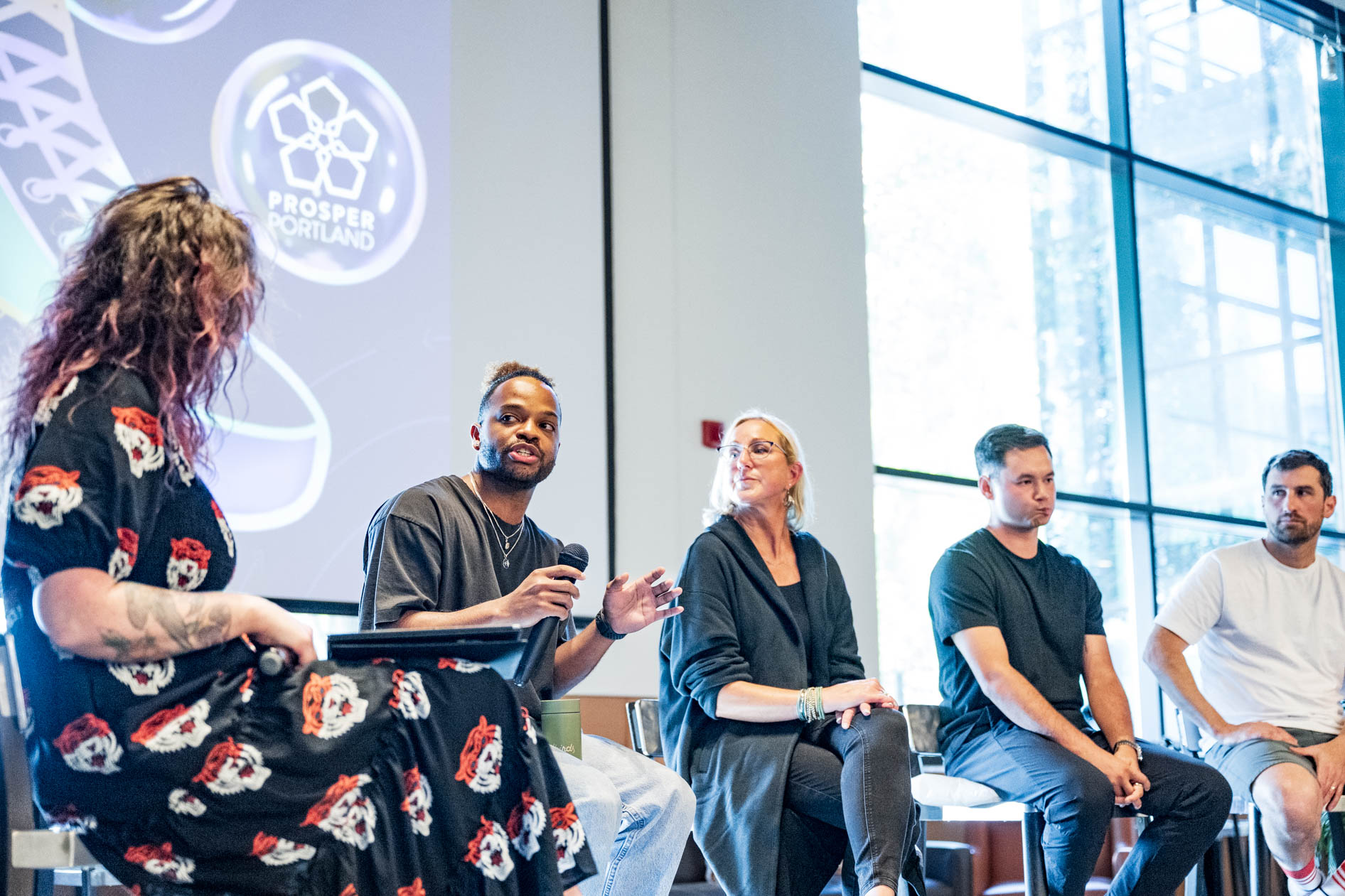 A candid photo of a panel discussion at Sneaker Week 2023 in Portland, featuring industry designers and veterans. This showcases conference photography.