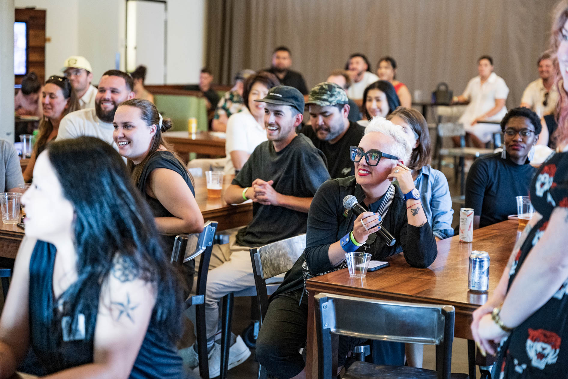 A candid photograph of an audience smiling and engaged during the Sneaker Week 2023 panel discussion. This showcases event photography in Portland.