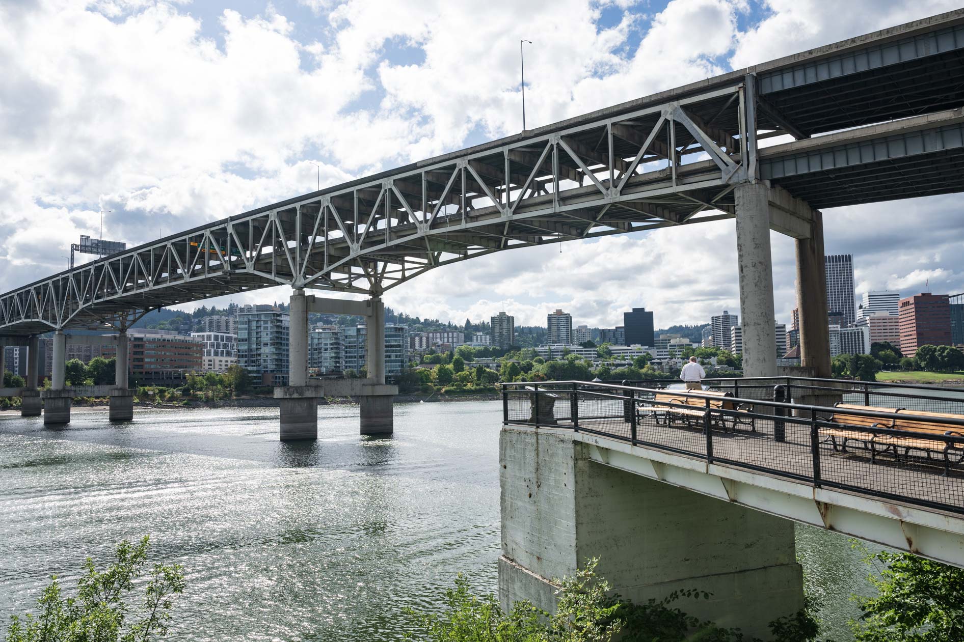 A wide view of the Marquam Bridge over the Willamette River, with the Portland skyline in the background. This showcases a key city landmark.