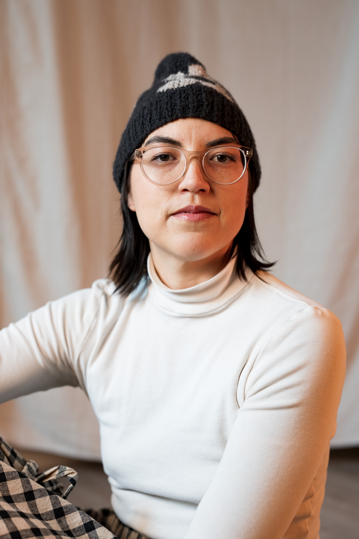 A professional inclusive portrait of Lee DeJonge wearing a knit beanie and glasses. This showcases creative portraits in Portland, Oregon.