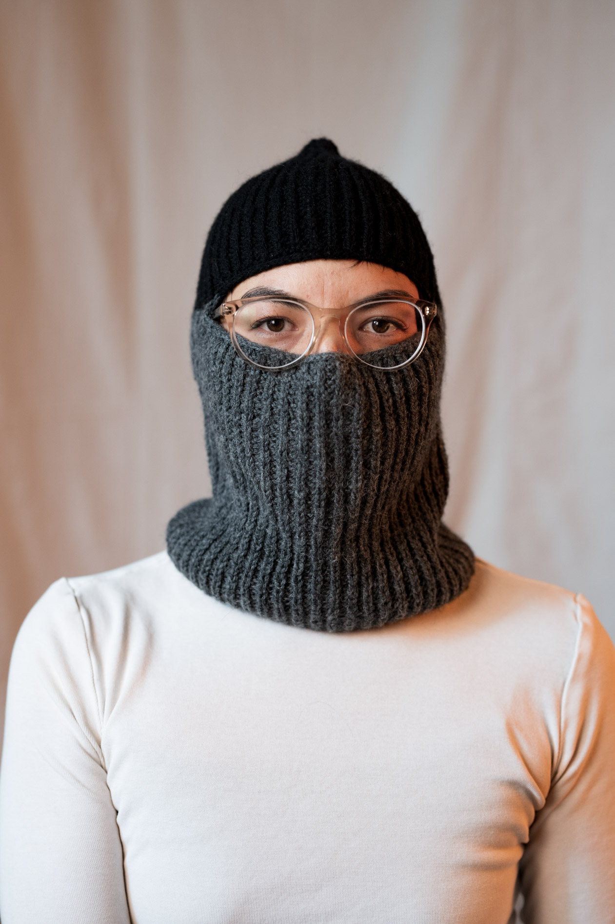 A creative inclusive portrait of Lee DeJonge wearing a custom-made black and gray knitted balaclava and glasses. This showcases creative portraits in Portland, Oregon.