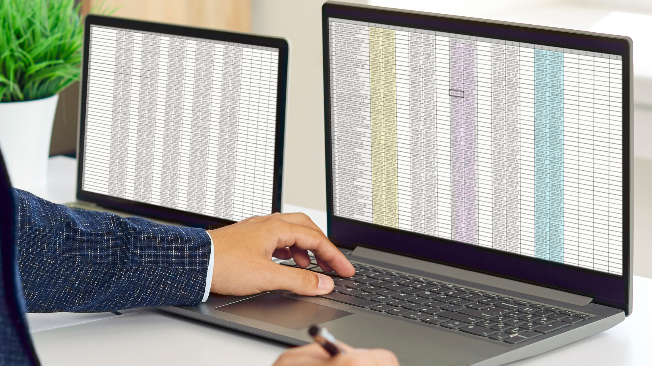 Two laptops displaying spreadsheet data for audit analysis